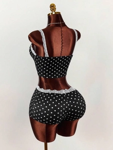 Rear view of two-piece pajama set with white polka dots and lace trim details