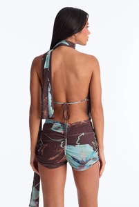 Back view of a floral halter top and ruched shorts set with a deep brown and blue print