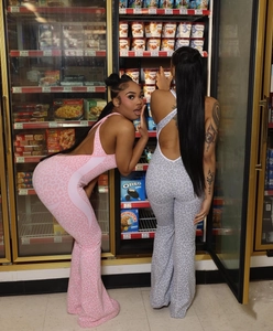 Detailed view of leopard print jumpsuits featuring flared legs and open-back design