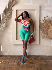 Summer set with multicolor one shoulder printed top and bright green cycling shorts