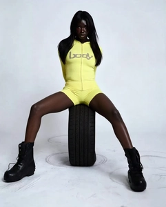 Tight yellow hooded long sleeve bodysuit with body print and elastic fabric on tire