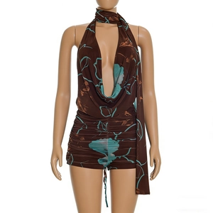 Detail of floral halter neck romper with deep V-neckline and matching scarf accessory