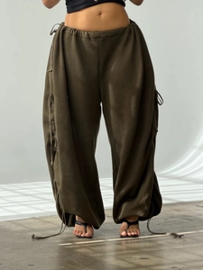Women's baggy olive green cargo pants with drawstring waist and adjustable legs