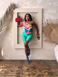 Chic two-piece summer set with vibrant one-shoulder top and green capri leggings