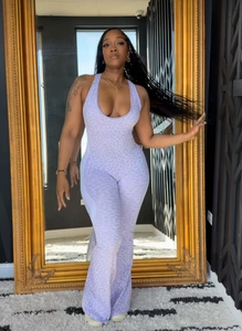 Detail of lavender leopard print jumpsuit featuring a halter neck and slim fit waist
