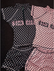 Detailed flat lay of children's two-piece polka dot swimsuits with Star Girl printing