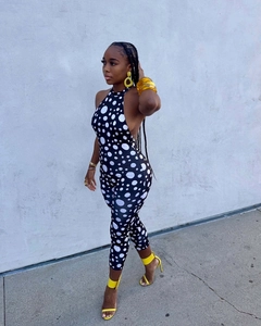 Detailed close-up of a sexy halter neck backless jumpsuit with black and white polka dots