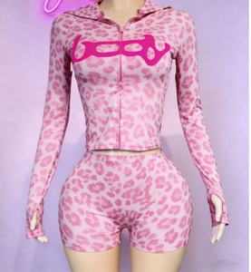 Detail of pink leopard print hoodie with thumbholes and matching tight shorts set