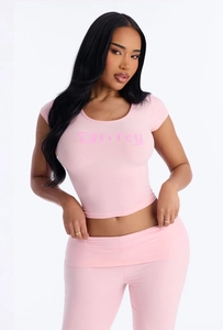 Detailed view of pink two-piece set featuring Wifey gothic print on a slim crop top