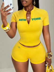 Women's yellow two-piece set with New York print crop top and matching slim shorts