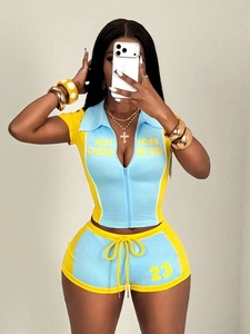 Detail of zipper crop top and shorts set with yellow and blue contrast color design