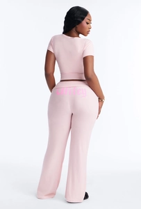Detail view of pink two-piece set featuring gothic wifey print on the back of trousers