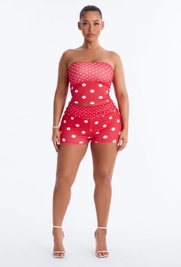 Detailed macro view of the red and white polka dot pattern on the two-piece slim fit set