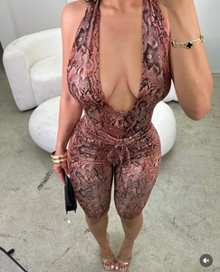 Detail of sexy deep V-neck and halter strap with brown snakeskin print jumpsuit