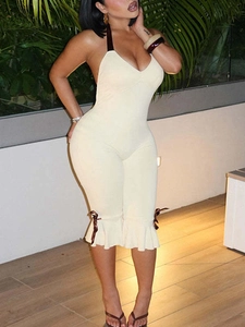 Sleeveless beige halter jumpsuit with ruffles and brown silk bows on legs