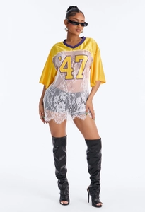 Detail of the yellow satin top with floral lace patchwork and number 47 print