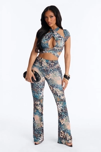 Detailed view of women's halter crop top and flared pants in blue animal print