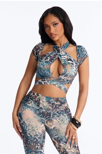 Detail of cross halter neckline with teardrop cutout on printed two-piece set