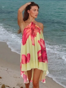 Detail of floral halter neck mini dress with irregular hem and open back for summer