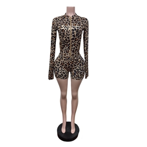 Detail of slim fit leopard print jumpsuit with gold zipper and stand collar