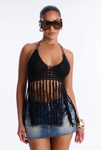 Close-up of black crochet halter top featuring intricate hand-woven texture and long tassels