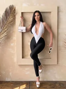 Chic black and white halter neck jumpsuit with deep V-neckline and backless design