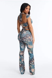 Detail view of backless halter top and flared pants with blue animal print