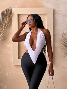 Sexy deep V-neck halter bodysuit in white paired with high waist black slim leggings
