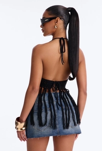 Detail of black crochet halter top with backless design and long bohemian fringes