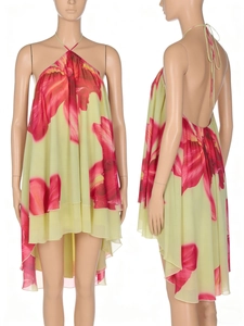 Detail of backless halter floral dress with layered ruffled hem and red flower print