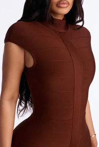 Detail of high-neck chocolate brown bandage dress with textured cap sleeve design