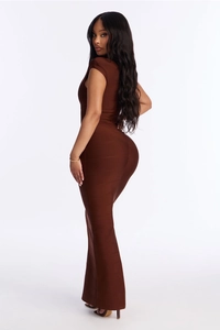 Close-up of side profile of dark brown bandage maxi dress with mermaid hem and tight fit