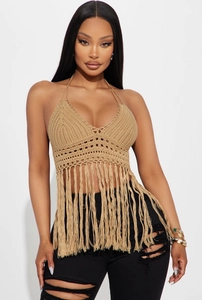 Detailed close-up of khaki crochet knit texture and long fringe hem on halter top
