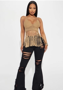 Detail of crochet halter top with long fringe hem and khaki woven texture close-up