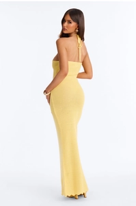 Detailed back view of a yellow knitted halter maxi dress with cutout tie-back design