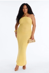 Detail of light yellow knit halter maxi dress with metal ring and textured pattern