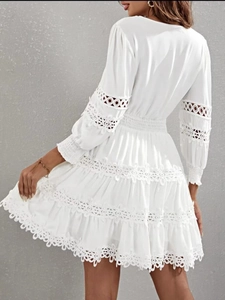 Elegant white lace cutout A-line dress with lantern sleeves and tiered skirt back view