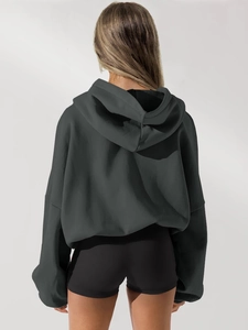 Rear view of a dark grey oversized hoodie featuring a dropped shoulder design and hood