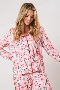 Detail of Christmas pajamas with candy cane prints and soft pink long sleeve top