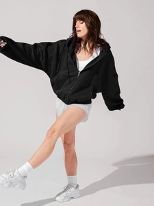 Dynamic view of women black oversized zip-up hoodie with adjustable drawstring and pockets