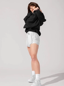 Close-up of black oversized hoodie material with adjustable drawstring hood and heavy fabric
