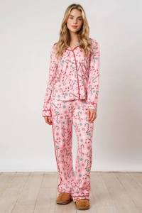 Pink pajamas set with Christmas candy cane prints and red piping detail on the collar