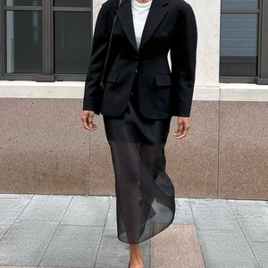 Women black slim fit blazer with double-layer mesh midi skirt outfit in urban setting