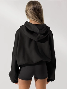 Rear view of black oversized hooded zip-up sweatshirt with drop shoulder design