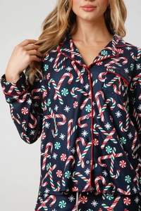 Close-up of Christmas candy cane patterns and soft fabric texture on pajama set