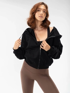 Detail view of women's black zip-up hoodie featuring ribbed cuffs and metal zipper closure