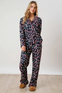 Close-up of Christmas candy cane and snowflake print on navy blue long pajama set