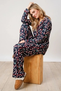 Detailed view of long-sleeve Christmas pajamas with candy cane and snowflake patterns