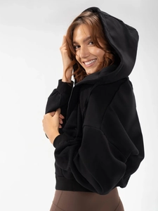 Detail of a black women's zip-up hoodie featuring a drawstring hood and ribbed cuffs