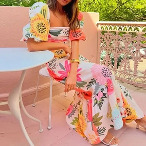 Detail of sunflower and pink floral print on white puff sleeve A-line maxi dress